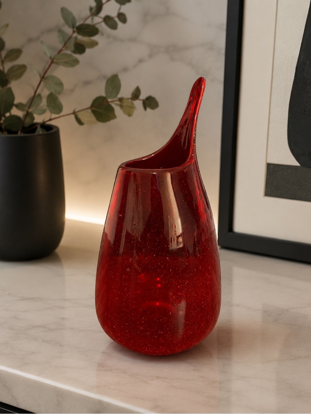 Hand-blown red art glass vase with pulled spout.